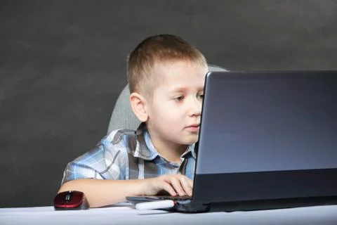 Computer addiction child with laptop notebook Stock Photos