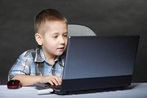 Computer addiction child with laptop notebook Stock Photos