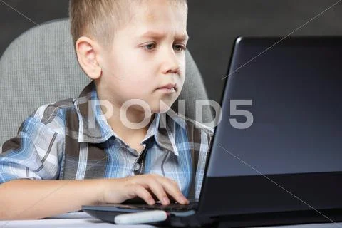 Computer addiction child with laptop notebook Stock Photos