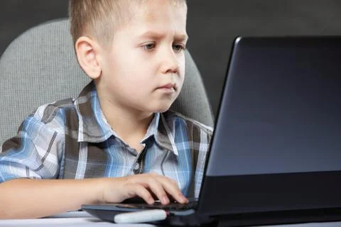 Computer addiction child with laptop notebook Stock Photos