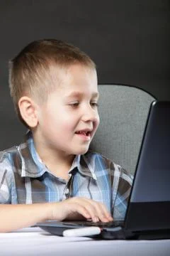 Computer addiction child with laptop notebook Stock Photos