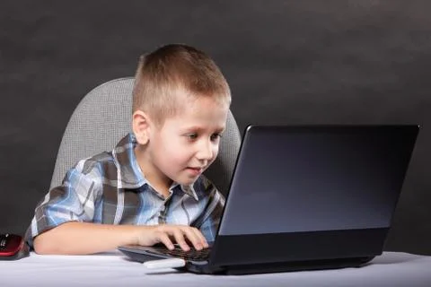 Computer addiction child with laptop notebook Stock Photos