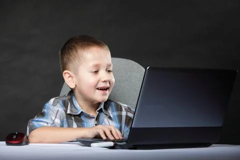 Computer addiction child with laptop notebook Stock Photos