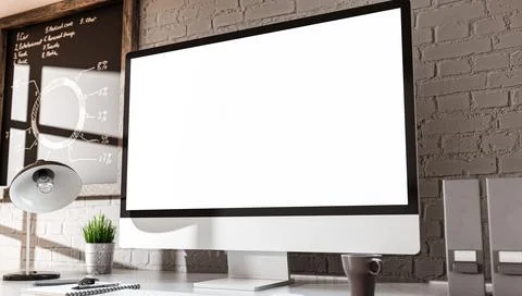 Computer all-in-one with a blank screen in industrial loft office interior Ilustración de archivo