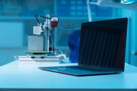 Computer and 3d printer on table in industrial design lab 스톡 사진