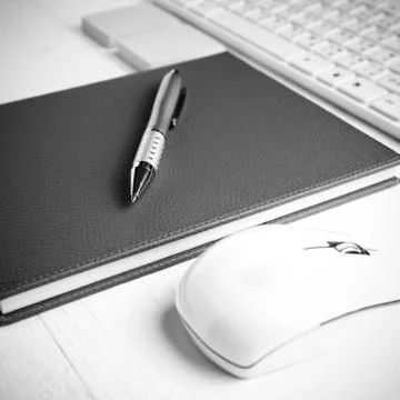 Computer and brown notebook with office supplies black and white style Stock Photos