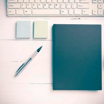 Computer and brown notebook with office supplies vintage style Stock Photos