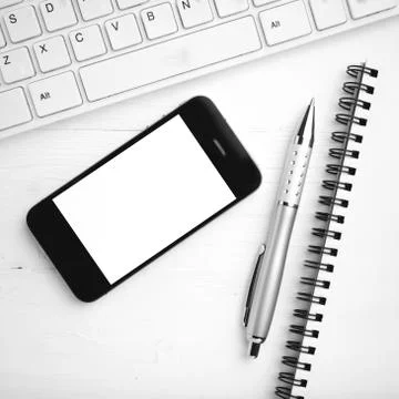 Computer and cellphone with notebook and pen black and white color style Stock Photos