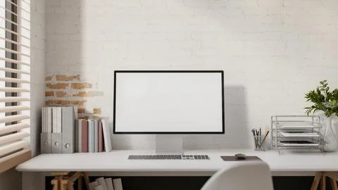 A computer and decorative items placed on a white desk against a white bric.. Stock Illustration