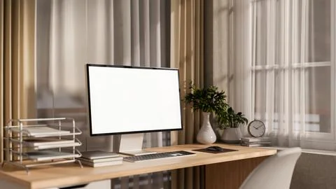 A computer and decorative items on a wooden desk by the window in a cozy co.. Stock Illustration