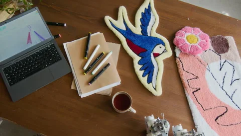 Computer and Handmade Rugs on Table in Rug Tufting Studio Stock Footage 316495747