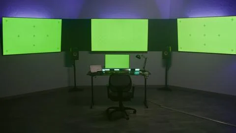 Computer and monitors with green screen in color correction studio Stock Photos