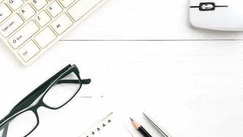 Computer and notepad with pen Stock Photos