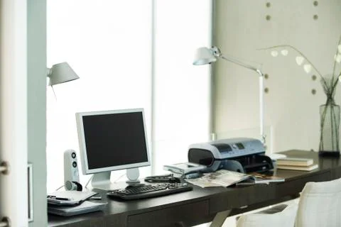 Computer and printer on desk in home office Stock Photos