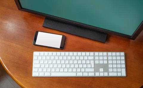 Computer and Smartphone on the Desk Фото