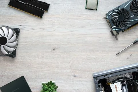 Computer assembly concept. Composition of computer parts on wooden desk. Copy Stock Photos