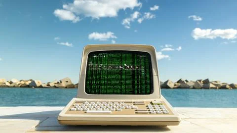 Computer on a beach with data and code on screen Foto stock