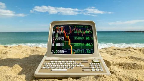 Computer on a beach with data and code on screen Stock Photos
