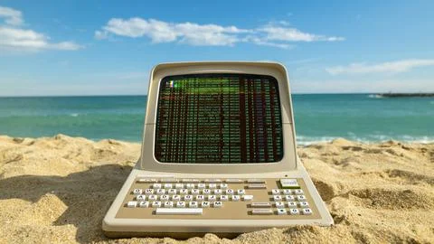 Computer on a beach with data and code on screen Stock-Fotos