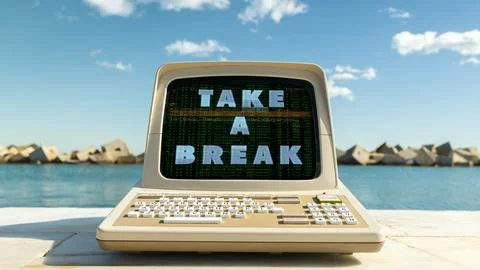 Computer on a beach with words take a break on screen Stock Photos