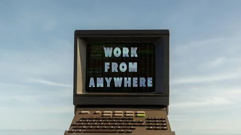 Computer on a beach with words work from anywhere on screen 스톡 사진