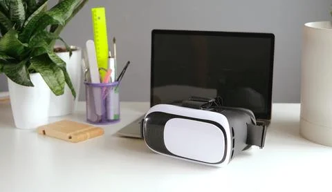 Computer with blank screen and virt ual reality glasses with headphones Stock Photos