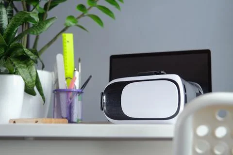 Computer with blank screen and virt ual reality glasses with headphones Stock Photos