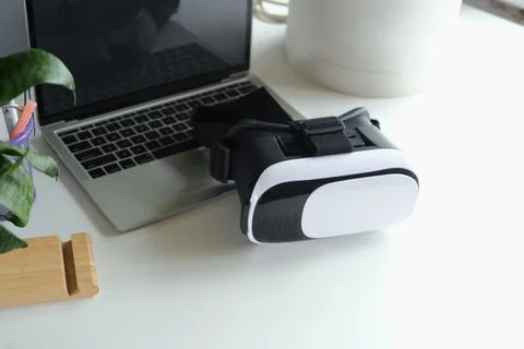 Computer with blank screen and virt ual reality glasses with headphones Stock Photos