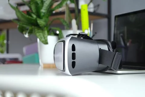Computer with blank screen and virt ual reality glasses with headphones Stock Photos