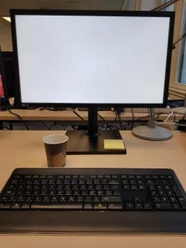 Computer with blank white screen on table. Stock Photos