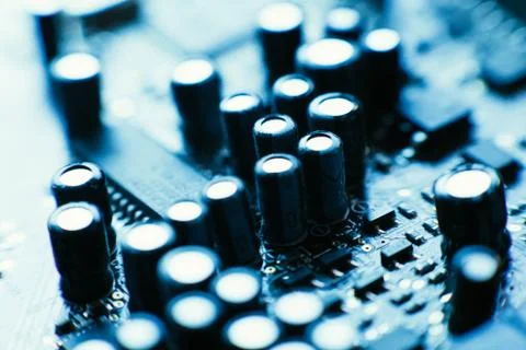 Computer board capacitors blue color close-up Stock Photos