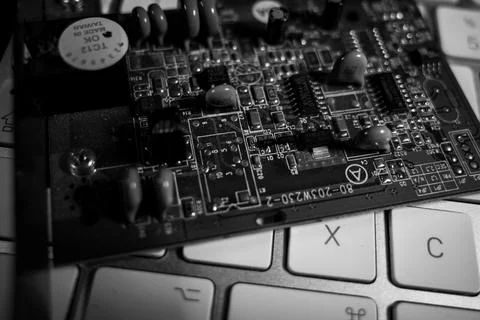Computer board lies on a white keyboard 스톡 사진