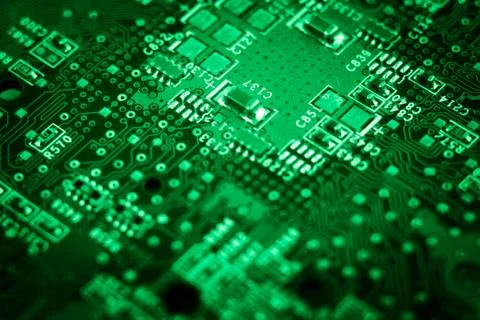 Computer board. microchip in green light. Stock Photos