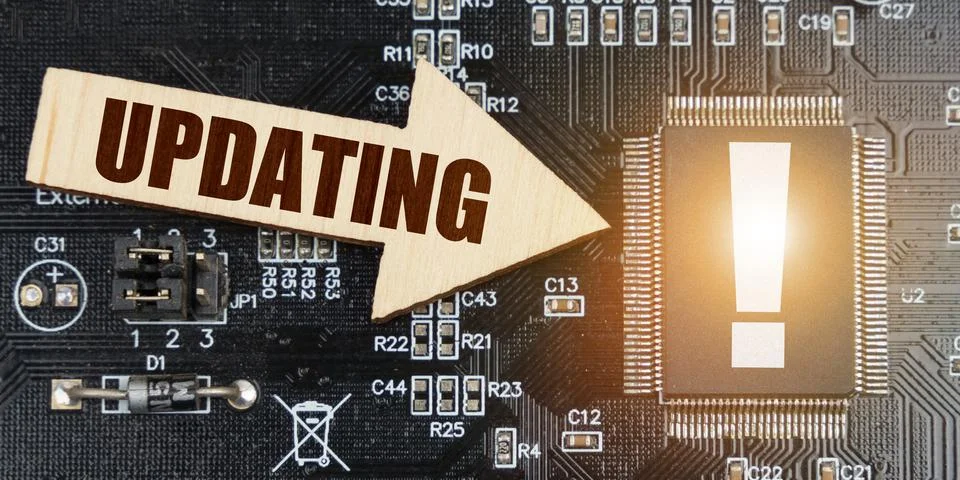 On the computer board, a microcircuit with an exclamation mark and an arrow w Stock Photos