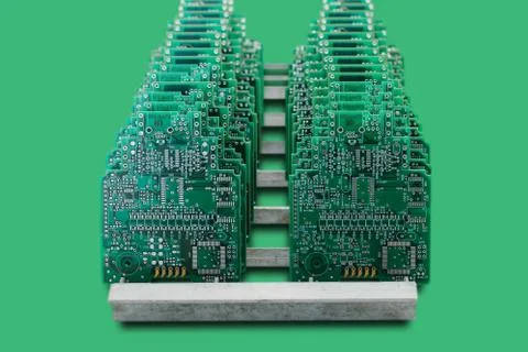Computer boards in a row on a green background Stock Photos