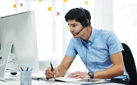 Computer, call center and man writing notes for banking, customer service or 스톡 사진