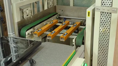 The computer case moves along a conveyor belt and is loaded into an elevator. Video stock 152511651