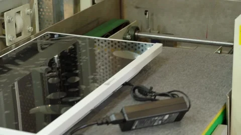 The computer case moves along a conveyor belt and is loaded into an elevator. Video stock 159014848