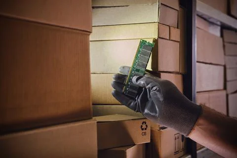 Computer chips memory ram in the hands of a man warehouse worker. The crisis  Stock Photos