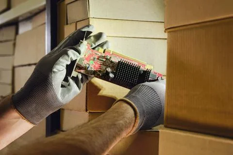 Computer chips video card in the hands of a man warehouse worker. The crisis  Stock Photos