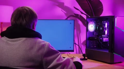 Computer with chroma key green screen on monitor. Gamer man playing in popular Stock Footage 270479747