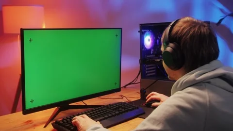 Computer with chroma key green screen on monitor. Gamer man playing in popular Stock Footage 270479891