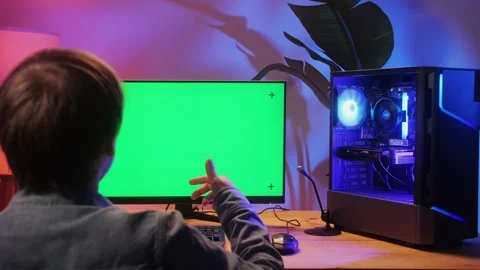 Computer with chroma key green screen on monitor. Gamer man playing in popular Stock Footage 270479982