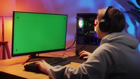 Computer with chroma key green screen on monitor. Gamer man playing in popular Stock Footage 272478347