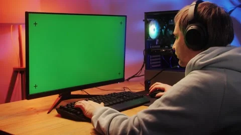 Computer with chroma key green screen on monitor. Gamer man playing in popular Stock Footage 274320549