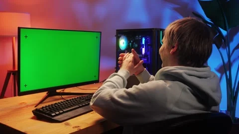 Computer with chroma key green screen on monitor. Gamer man playing in popular Stock Footage 274320558