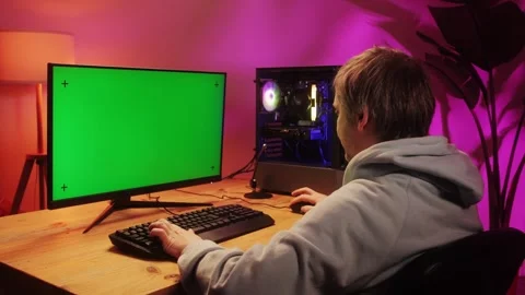 Computer with chroma key green screen on monitor. Gamer man playing in popular Stock Footage 278536316