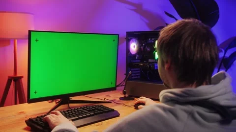 Computer with chroma key green screen on monitor. Gamer man playing in popular Stock Footage 278536368