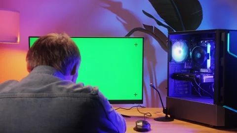 Computer with chroma key green screen on monitor. Gamer man playing in popular Stock Footage 280586766