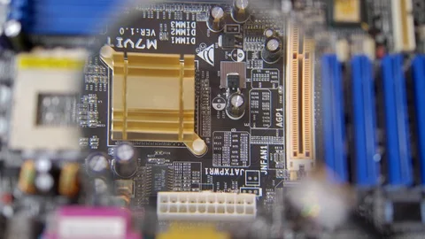 Computer Circuit Board with Electronic Chips under Magnifying Glass Stock Footage 114609652